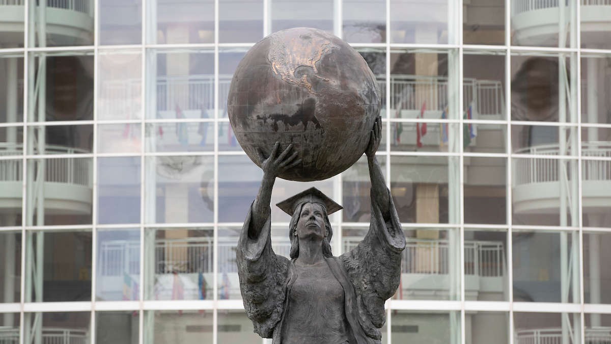 The Citizen Scholar statue: an academic woman holding up a globe