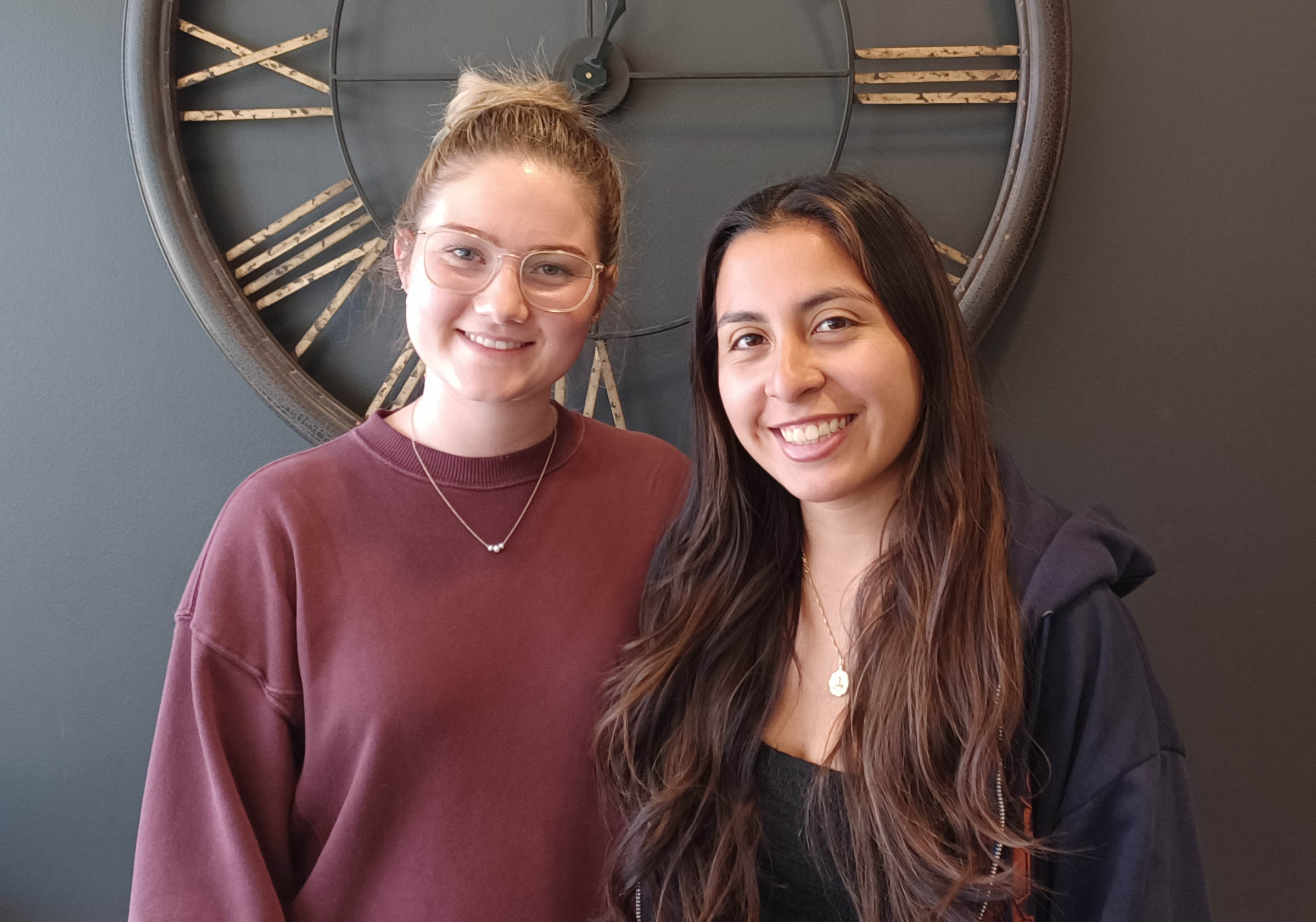 Two peer mentors smile into the camera