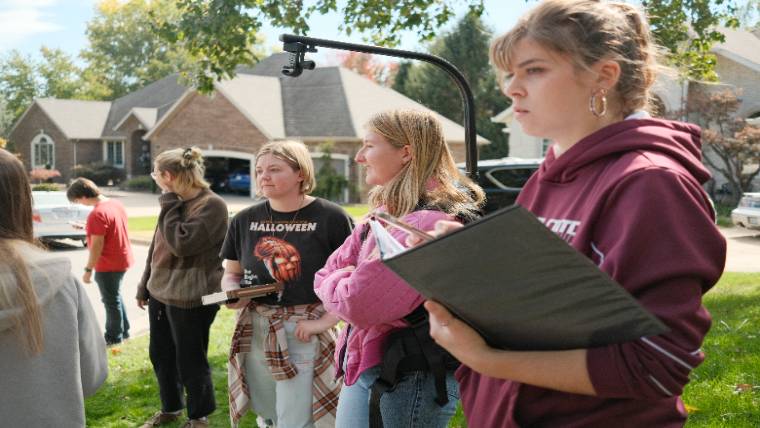 Students listening to a presentation outdoors