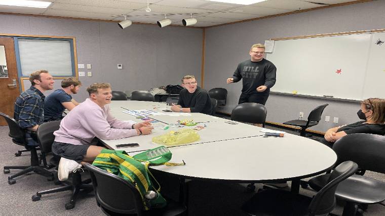 People gathered around a table in a classroom