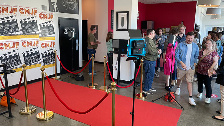 Students and patrons prepare to walk red carpet
