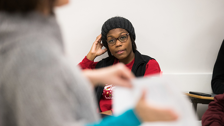 Student listening to professor in class.