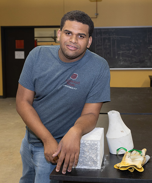 Luther Harris posing for a photo in an engineering <a href=