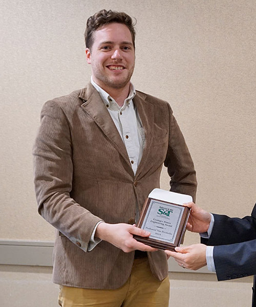 Electrical engineering student Nathaniel Van Devender accepting a scholarship award at a banquet