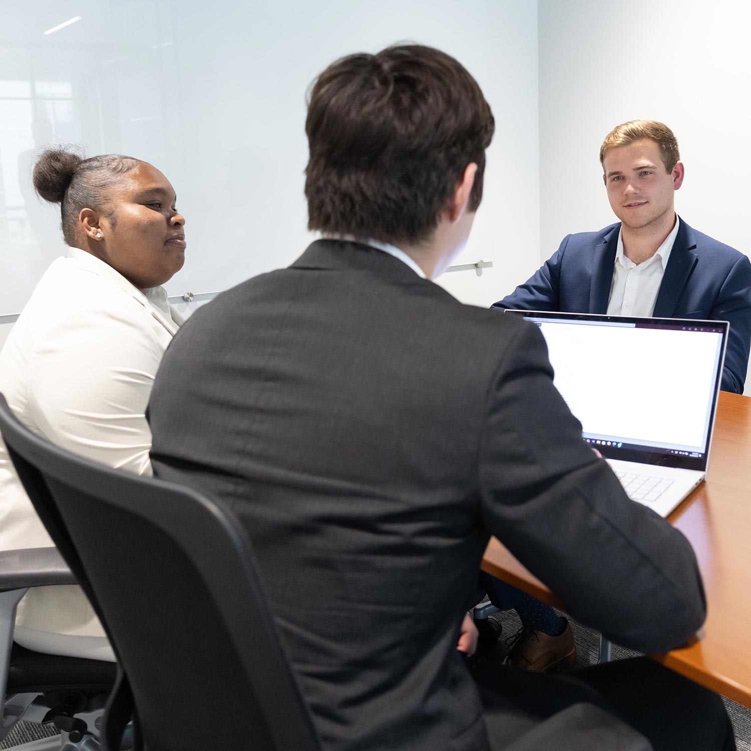 A client meets with two financial planning students from Bear Essentials.