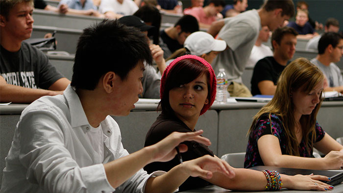 Student helping another student in class.