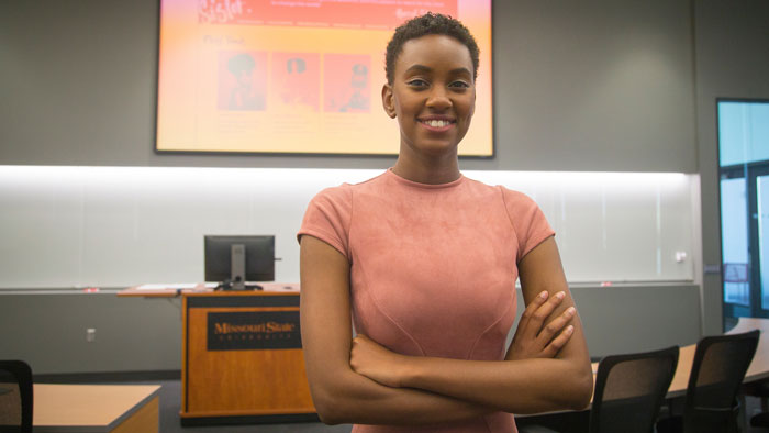 Maya Sudduth posing in front of camera after senior project presentation