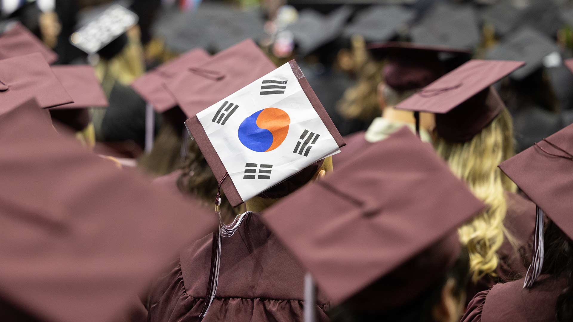 A drawing of the South Korea flag, the Taegeukgi, taped on a student's mortarboard during a commencement ceremony.