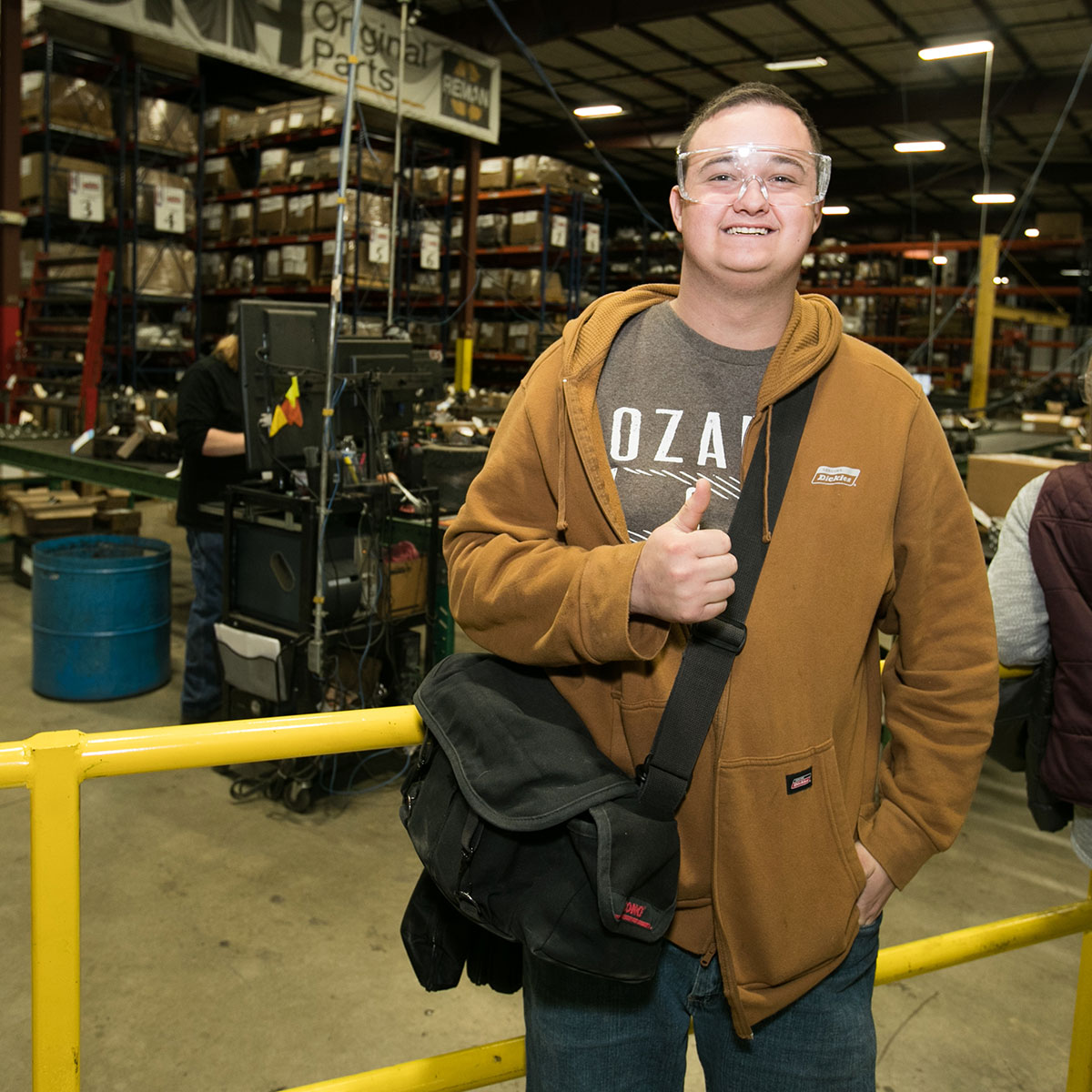 An MSU student smiles as he tours an industrial supply facility.