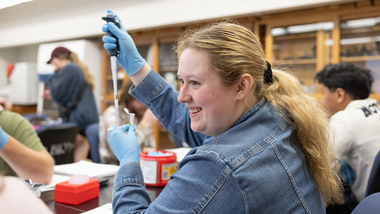 Missouri State student within a biology lab.