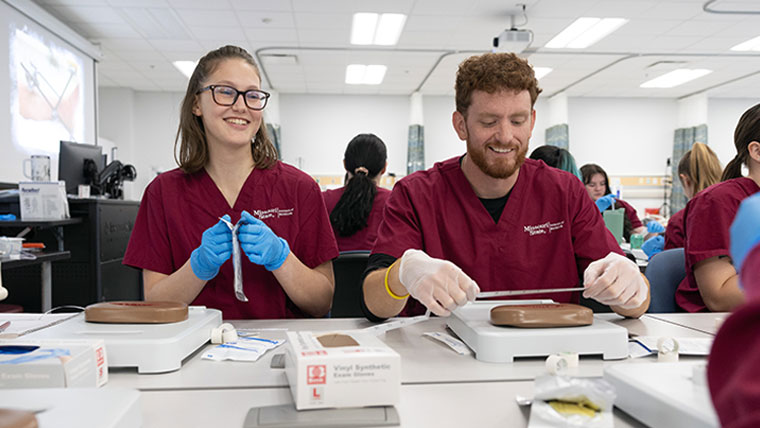 Two Missouri State medical students working within a lab.