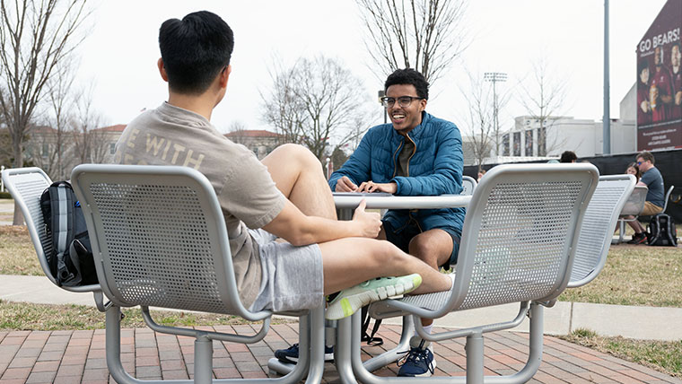 Two Missouri State students enjoying a warm day on campus.