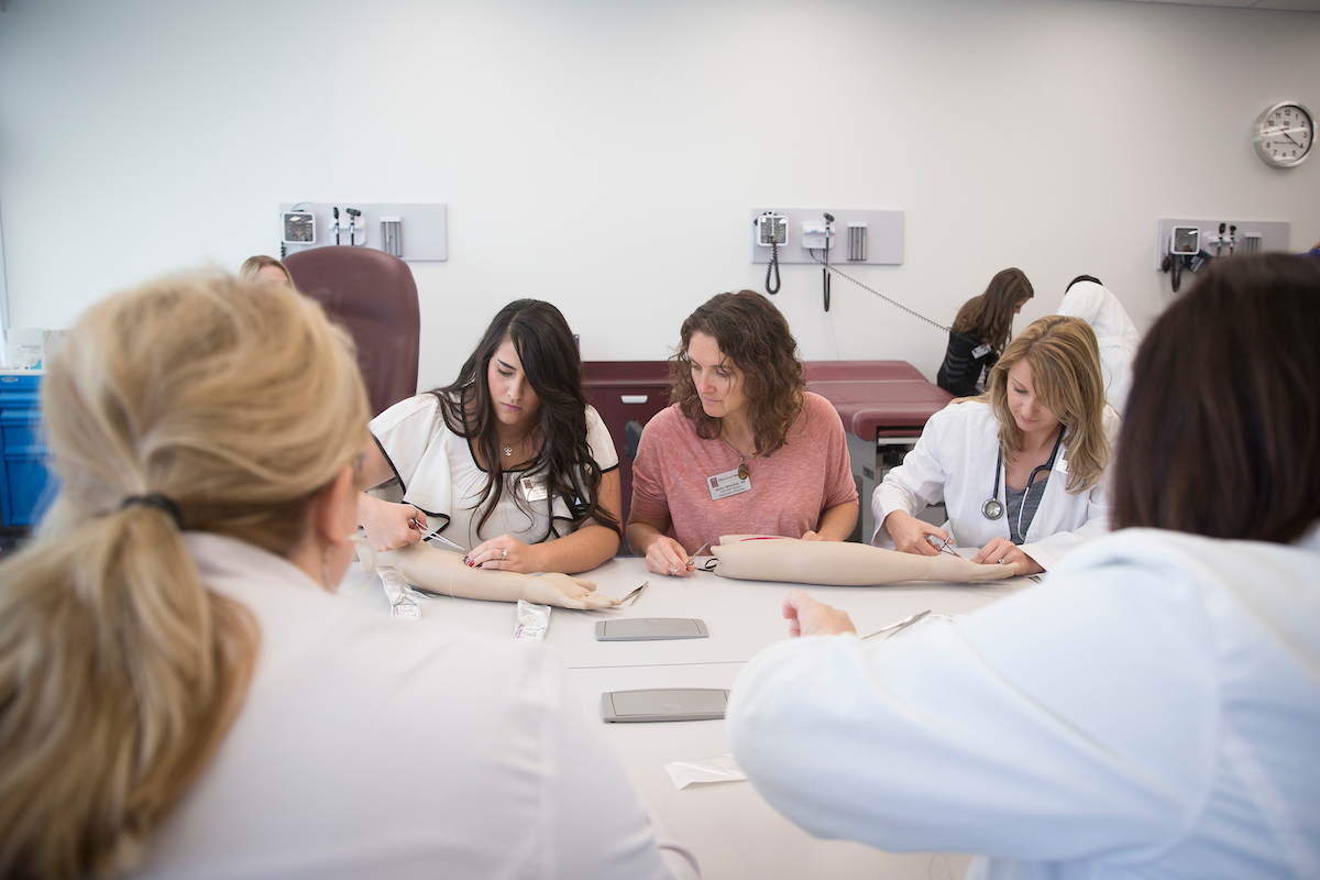 Student in MCHHS simulation lab working with a manniquen patient