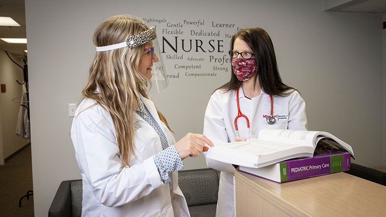 Nursing professor Brandon Rachal instructing class in simulation lab.