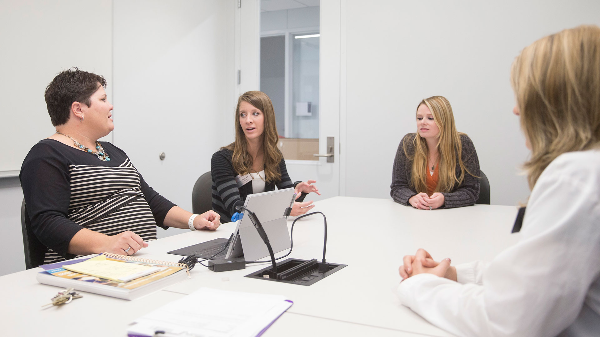 Nursing students and an instructor engage in a class discussion.