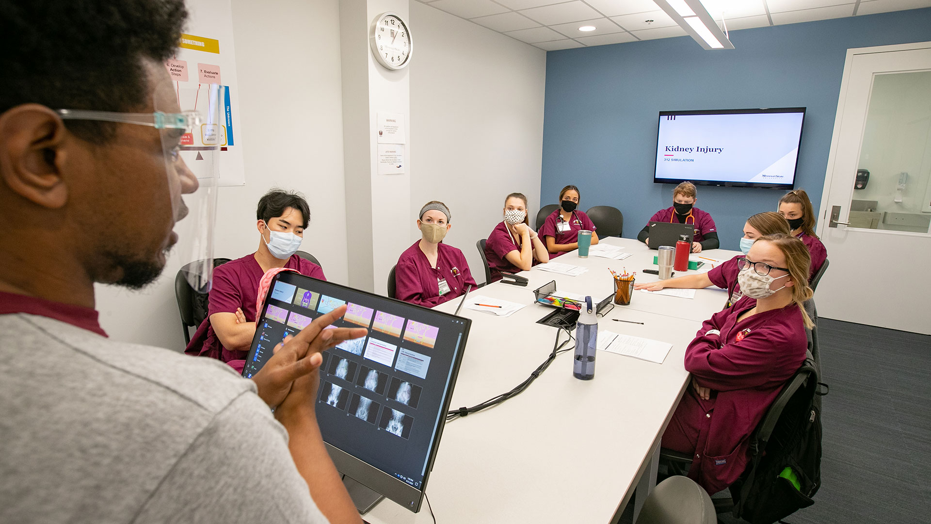 Nursing students learn about kidney injuries in the debrief room of the simulation lab in the O’Reilly Clinical Health Science Center