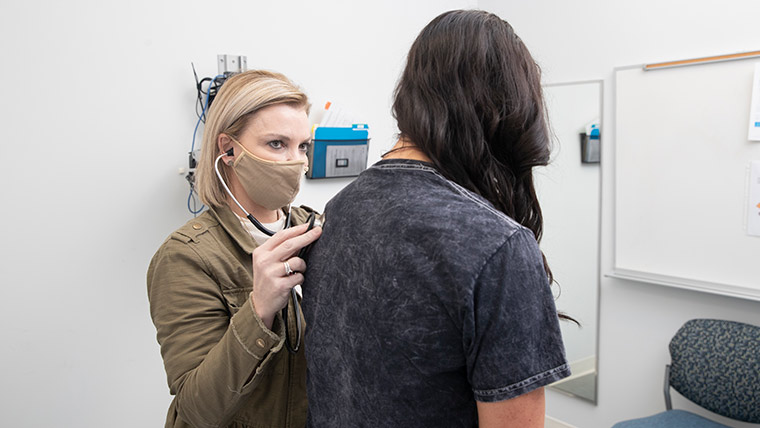 Nursing students demonstrating patient exam.