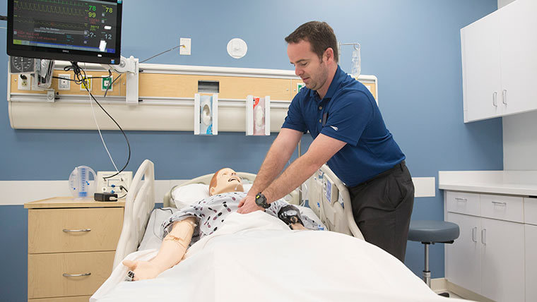 Student performing CPR on a fake patient.