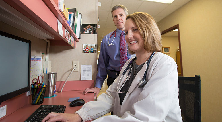 Professor helping a DNP student.