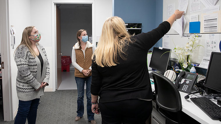 Students and professor in clinic office.