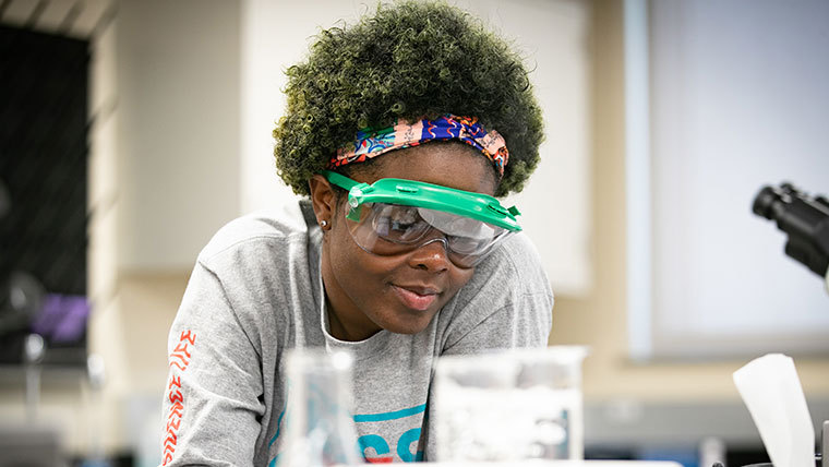 Pre-nursing student with scientific goggles on.