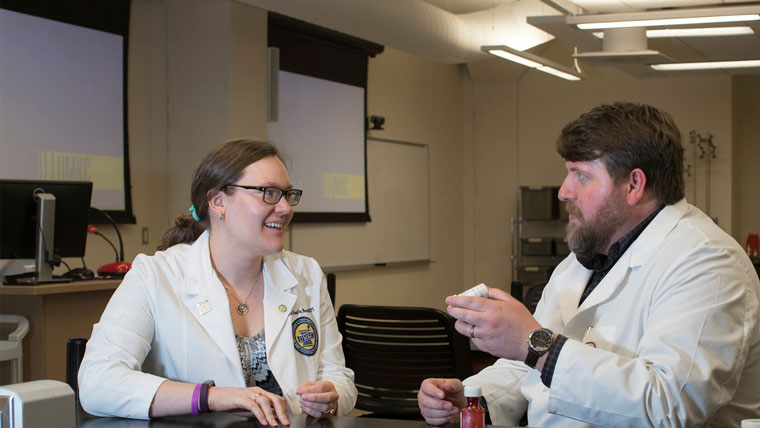 Two pharmacy students talking to eachother.