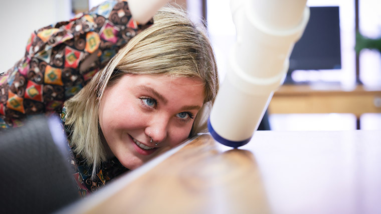 Student examining an object.