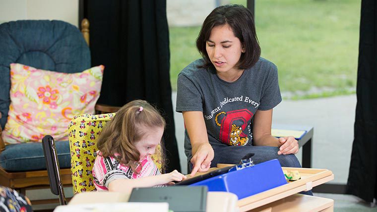 Student helping her student in class.