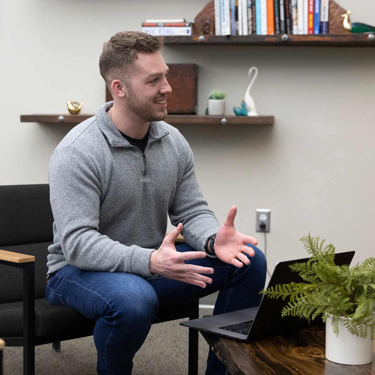 A smiling man having a friendly discussion in an office setting