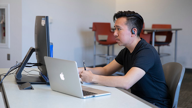 Student studying on his laptop.