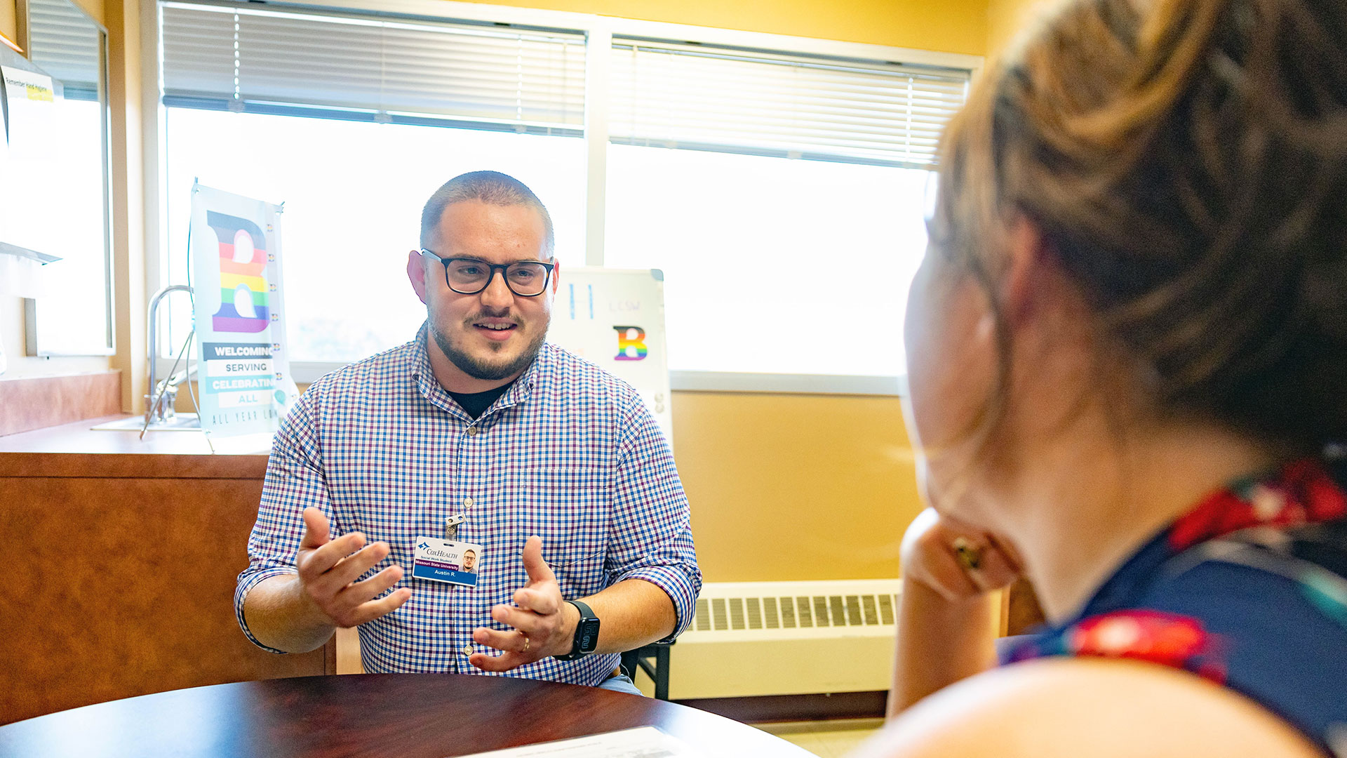 Two professionals sitting at a table in discussion.