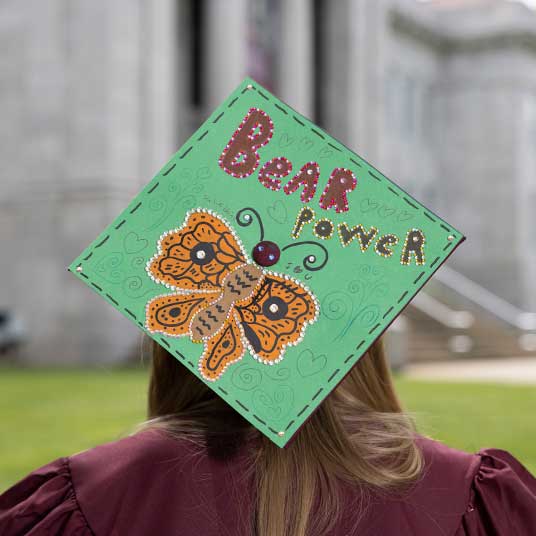 A student's graduation cap that says "Bear POWER"