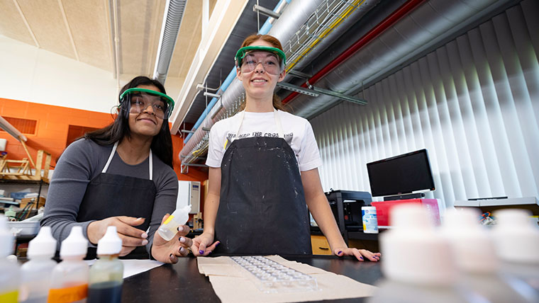 Two students smiling in a science lab