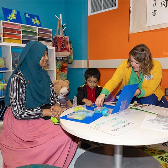 People teaching a child in MSU's Global Education Lab