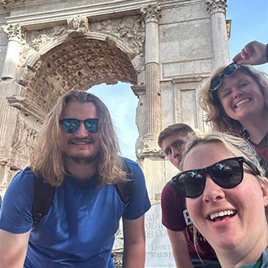 A group of MSU students visit the Arch of Titus.