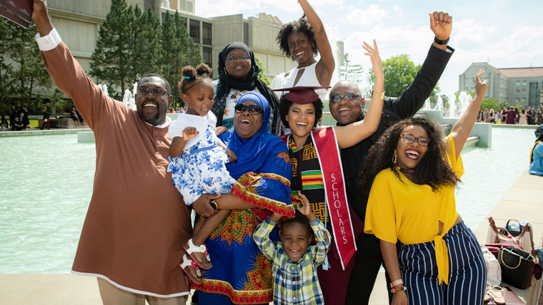 Missouri State family celebrates their graduate at the fountain.