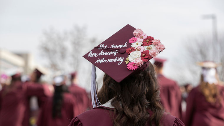 Graduate with cap and gown. 